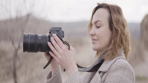 Woman Taking Photos with DSLR Camera Outdoors