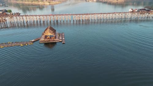 The beautiful Khwae Noi River with the Mon and Songkalia bridges in the background, creating a pictu