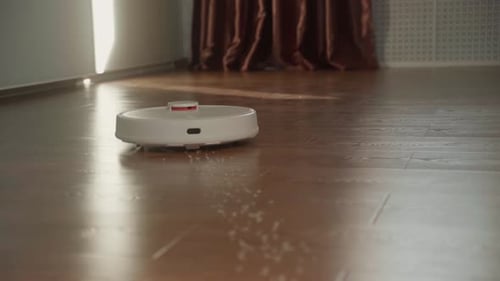 Robot Vacuum Cleaner Cleaning the Wooden Floor