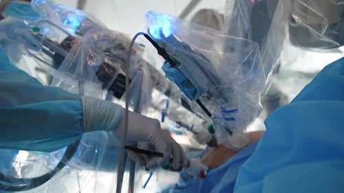 Surgeon Using Robotic Machine Arm During Medical Procedure