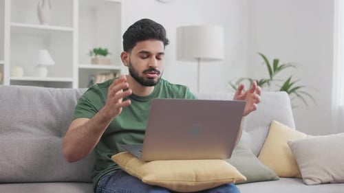 Young Adult Using Laptop on Couch