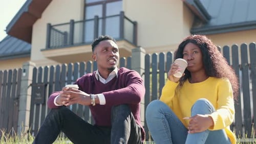 Young Adults Sitting and Drinking in Suburban Setting