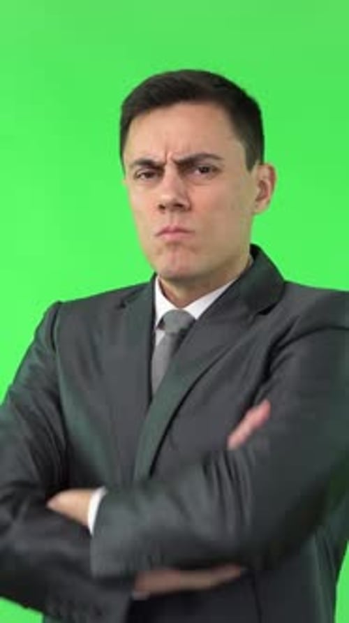 Man in Suit Holds Up Hand to Stop