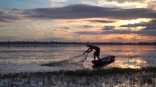 Men Working with a Fishing Net, Throwing Fishing Net on the river at early morning.