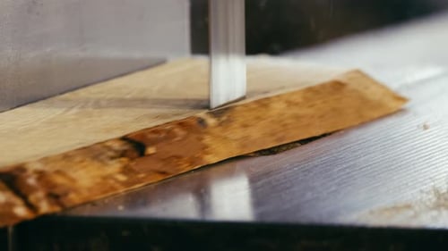 Blade Cutting Through Piece of Wood