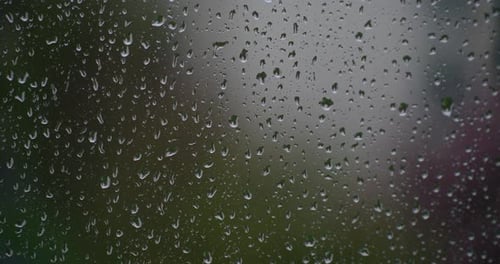Rain Drops Through Window Glass. Close Up
