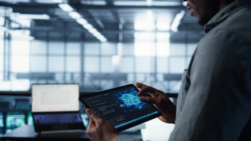 Close Up of Computer Scientist in Data Center Uses AI on Tablet