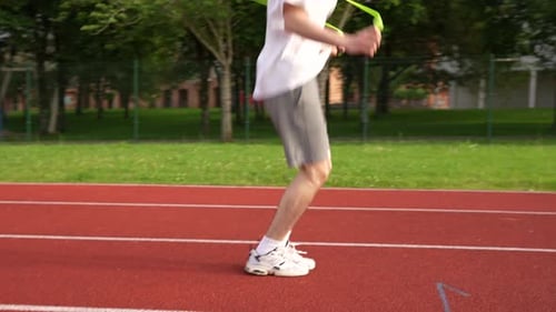 Man Jumps Rope on Outdoor Running Track