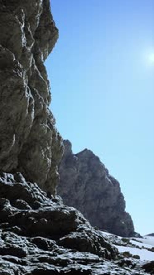 Rocky Outcrop in Sunlit Desert Terrain