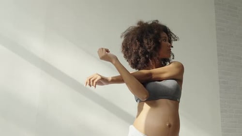 Pregnant Woman Stretching Arms During Prenatal Workout