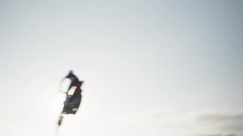 Motocross Rider Jumps on Dirt Track in Rural Area