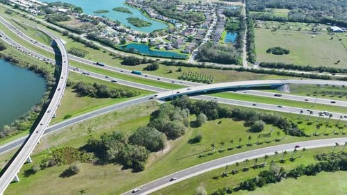 Aerial View of Freeway Overpass Junction with Fast Moving Traffic Cars and Trucks in American Rural