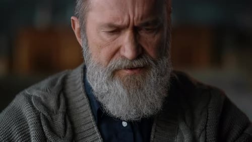 Senior Man Face Closeup. Old Man with Crossed Arms in Cabinet. Thoughtful