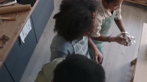 Family Making Cookies Together in Kitchen at Table