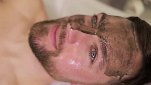 Man Receiving Facial Mask Treatment at Spa