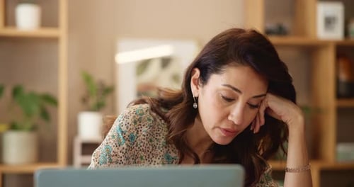 Woman Looks Tired While Working From Home
