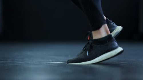 Side View on Kickboxer Feet at Gym. Closeup Unrecognizable Sportsman Jumping In