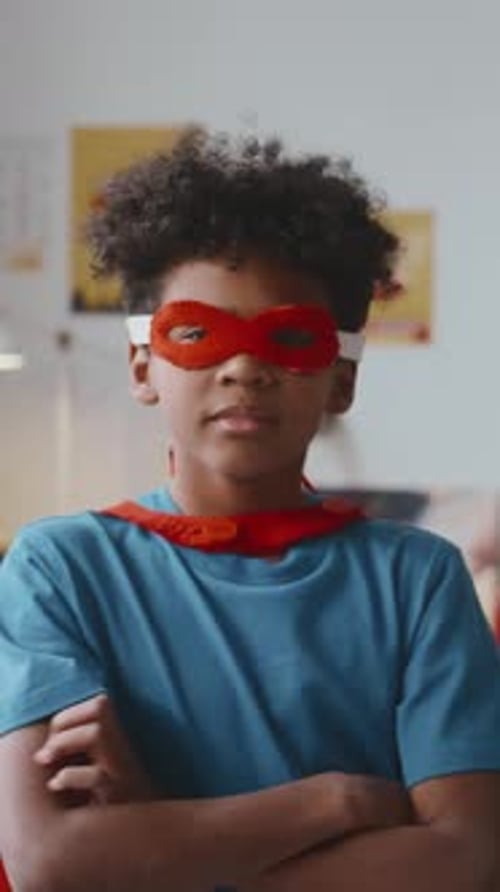 Boy Superhero Posing Indoors Wearing Cape and Mask