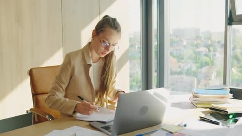 The Businesswoman is Very Focused on Her Work in a Modern Office Benefiting From Natural Sunlight