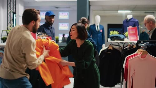 Retail Shoppers Fighting Over Clothing on Black Friday