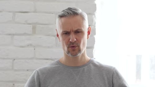 Man Massaging Temples Due to Headache or Stress