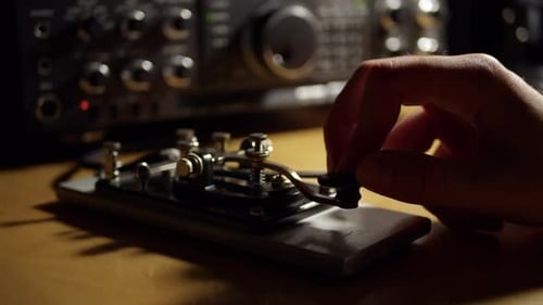 Morse Code Radio Telegraphy CW Ham Radio Straight Key with Radio in the Background