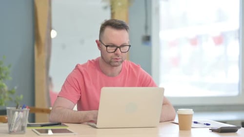 Man Typing on Laptop