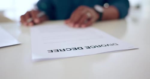 Person, hands and signing documents for divorce, legal agreement or form on table at home