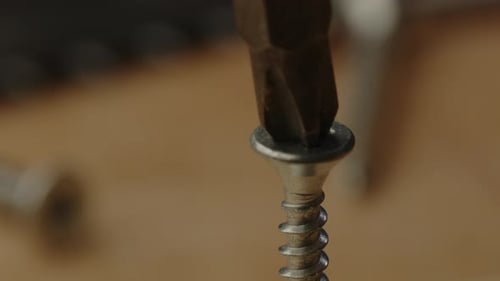 view of drill bit trying to screw in slanted screw with electric screwdriver
