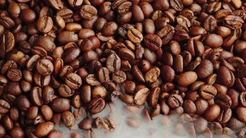 Roasting Coffee Beans with Smoke on Dark Background Close Up Arabica Robusta Colombian Beans