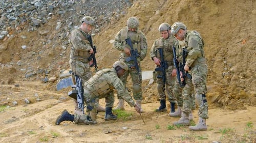 Front view of mixed-race military soldiers planing on field during military training 4k