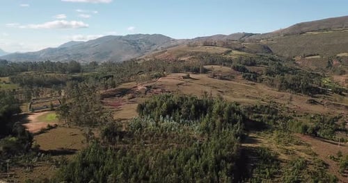 Aerial View of a Rolling Hills Landscape with Lush Greenery and Rural Terrain