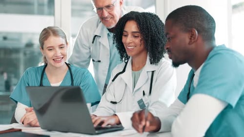 Medical Team Collaborating on Laptop in Hospital