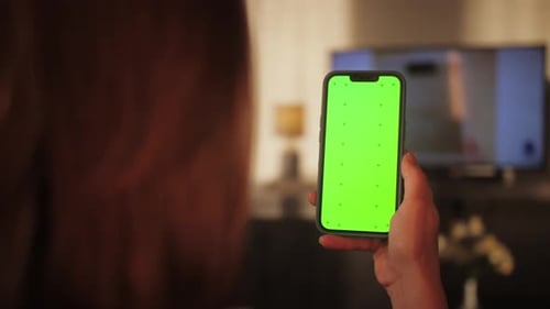 Woman Swiping Up Gesture on Chroma Key of Modern Smartphone Female Resting at Home and Using Phone
