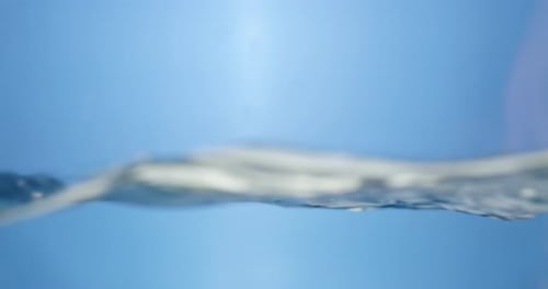 Water Surface Slow Motion Abstract Background. Bubbles rise to the surface. Fresh water waves with s