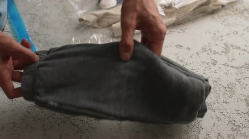 Folding Gray Sweatpants for Packing and Storage