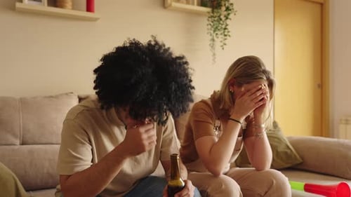 Football Fans Watching a Match at Home Reacting with Disappointment to a Missed Penalty on Tv