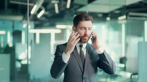 angry evil male businessman cry talking on the mobile phone in office. business man shouting on call