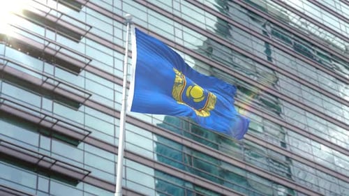 Waving Flag with Corporate Emblem in Front of Modern Building