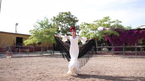 Flamenco Dancer Posing in a White Dress Outdoors