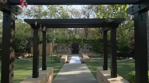 Wooden Wedding Arch with Path Leading to Building for Outdoor Wedding Ceremony