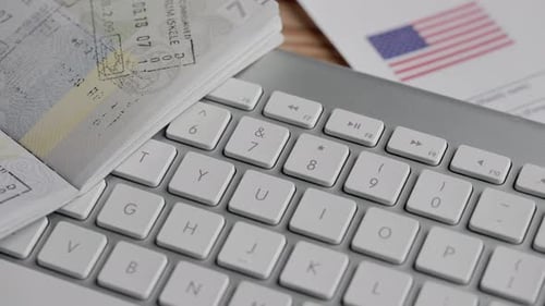 Passport, Keyboard, and Money on a Table