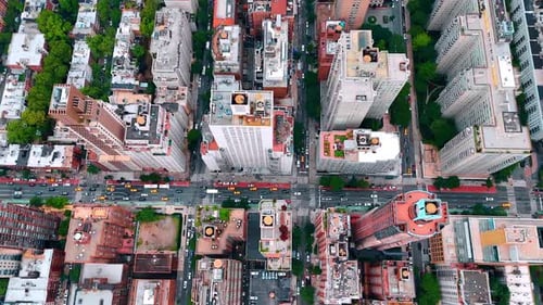 Multiple yellow cabs in the car flow on the multi-lane road. Top view on the streets of New York