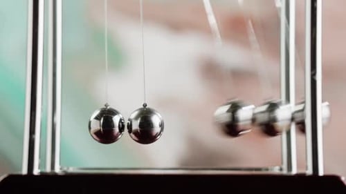 Newton's Cradle Demonstrates Momentum and Energy