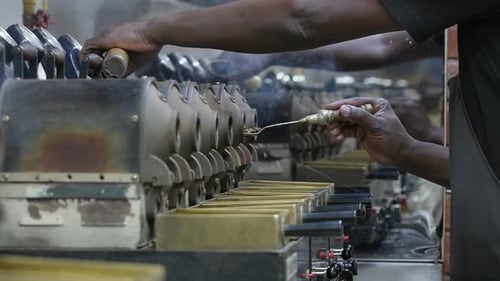 Man Using Industrial Machine to Make Food