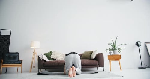 Senior Man Doing Headstand in Living Room