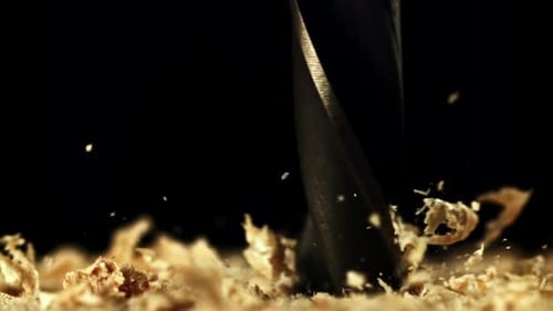 Drill Boring into Wood with Shavings Flying