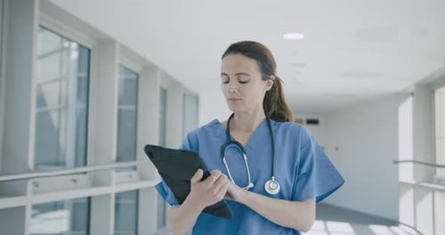Female Medical Nurse with Digital Tablet in Hospital