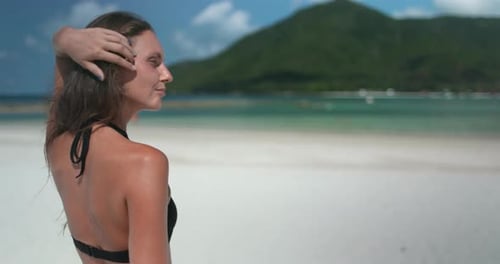 Woman in Bikini Walking on Beach