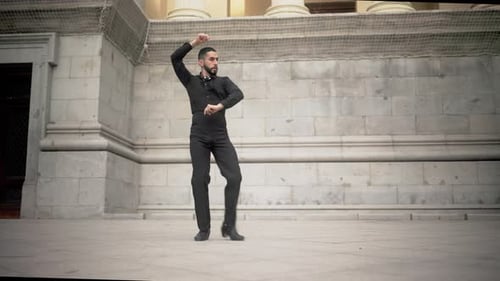 Hispanic man performing traditional flamenco dance in spain